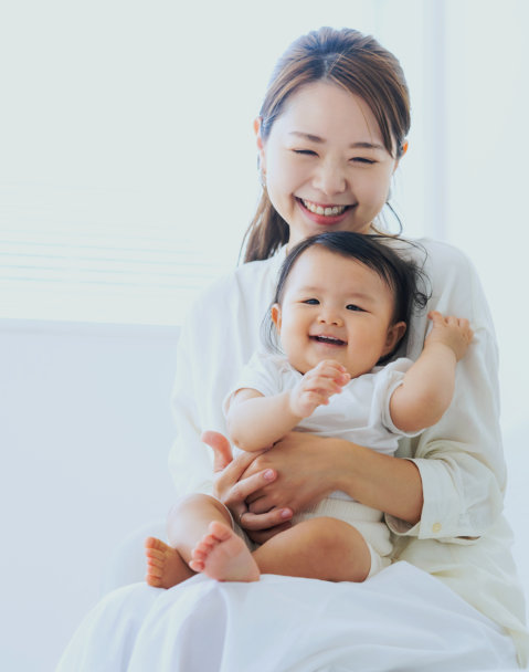 woman hugging an infant
