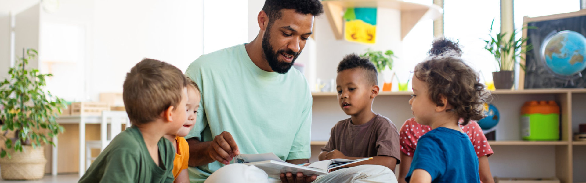 kids listening to their teacher reading them a story